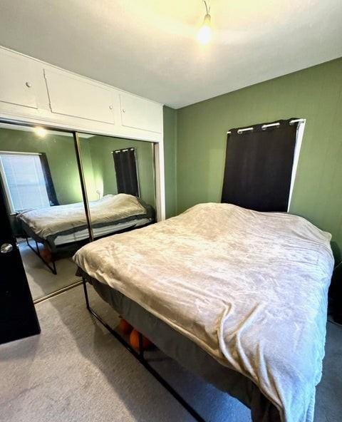 carpeted bedroom with a closet