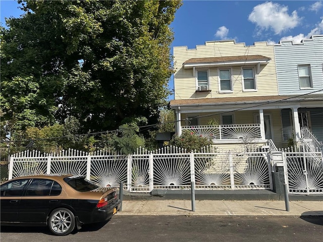 view of front facade with covered porch and cooling unit