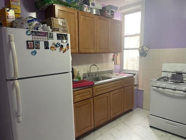 kitchen featuring white appliances and sink