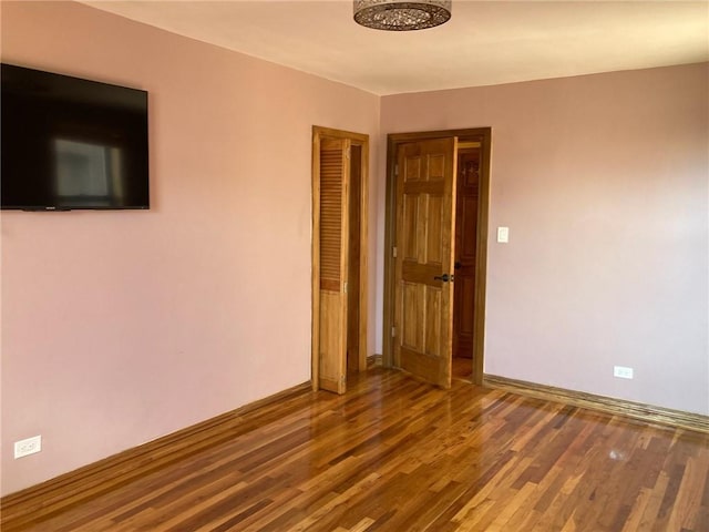 unfurnished room featuring wood-type flooring