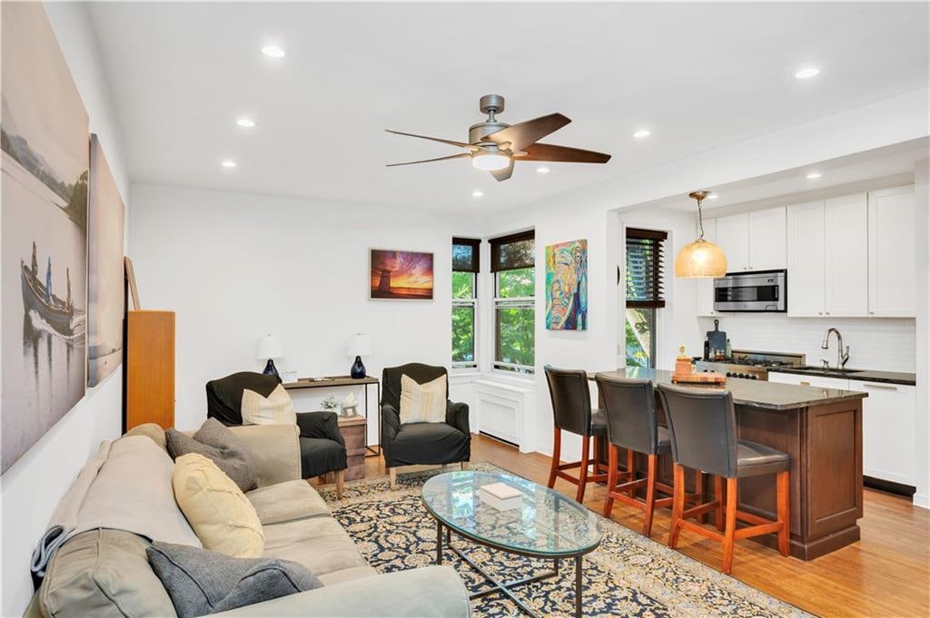 9707 4th Ave Unit 3R, Brooklyn, NY 11209 - living room with light hardwood / wood-style flooring, ceiling fan, and sink