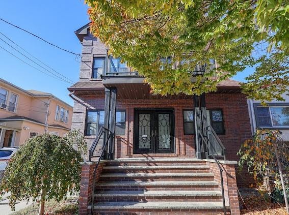 view of front of house featuring brick siding