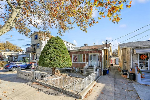 view of front facade with a fenced front yard and brick siding