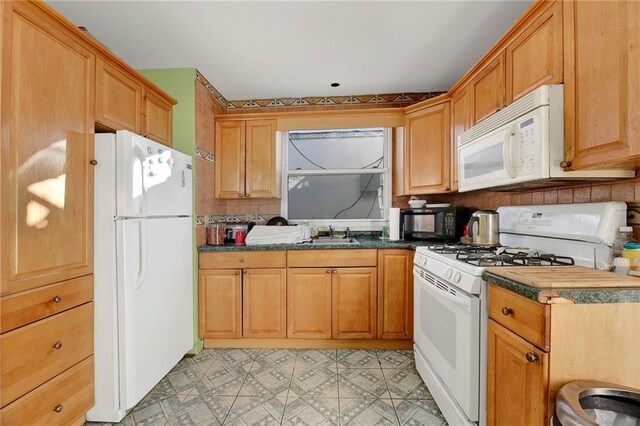 kitchen featuring sink and white appliances