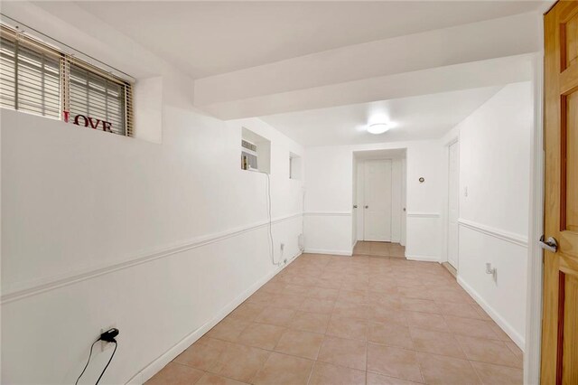 corridor featuring a wall mounted AC and light tile patterned floors