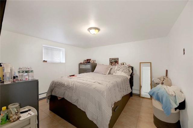 bedroom with light tile patterned flooring and a baseboard radiator