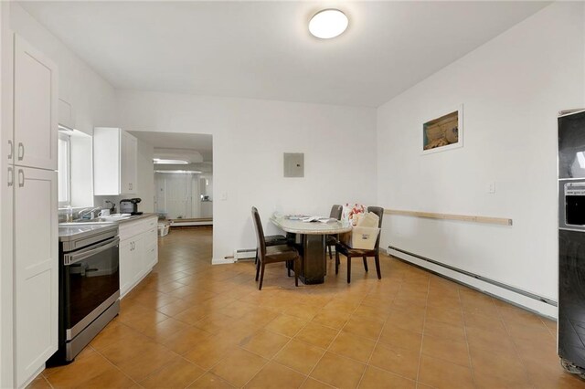 dining space with sink and baseboard heating