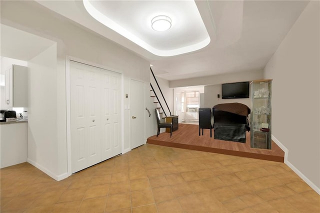 office space with a tray ceiling and a fireplace