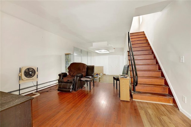 living area featuring a baseboard radiator and hardwood / wood-style floors