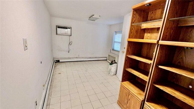 clothes washing area with an AC wall unit and a baseboard radiator