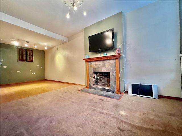 unfurnished living room with carpet floors and a fireplace