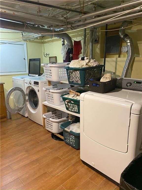 washroom featuring independent washer and dryer and hardwood / wood-style floors