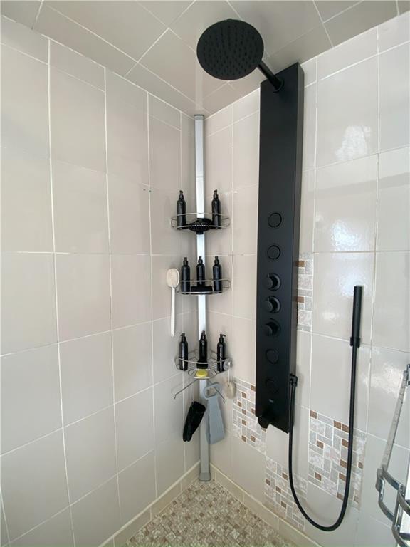 bathroom with tiled shower