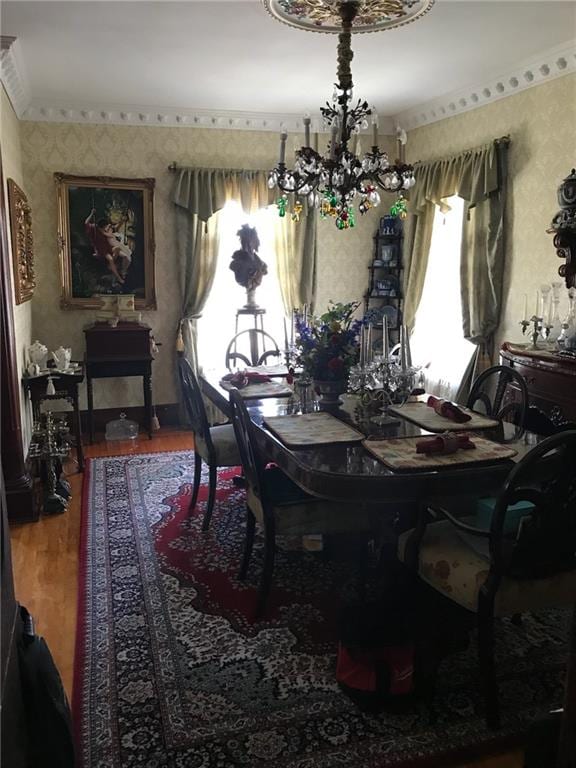 dining room with wood-type flooring and an inviting chandelier