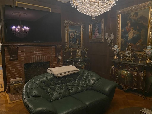 bedroom with a notable chandelier, parquet floors, and a brick fireplace