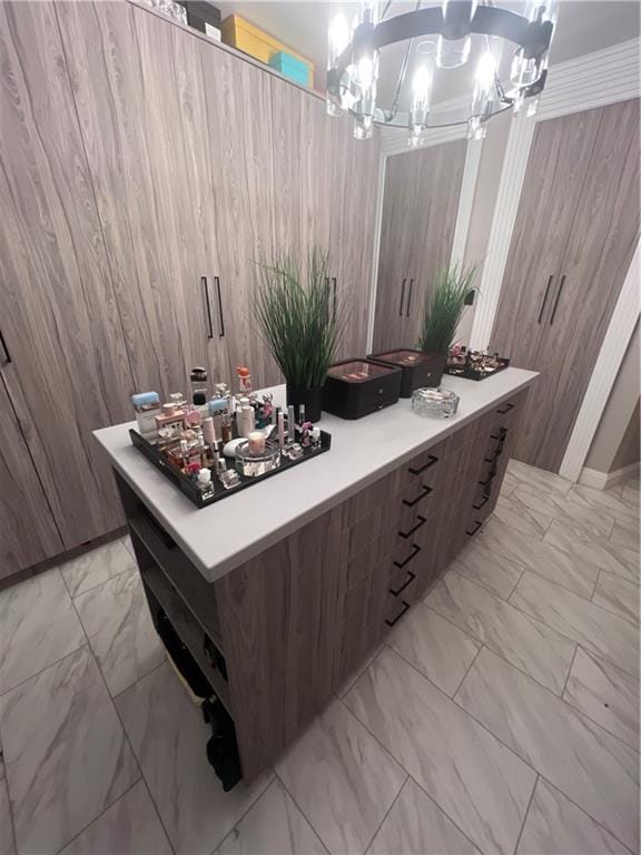 bathroom with wooden walls, crown molding, and a chandelier