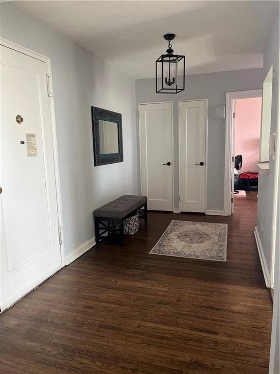 foyer featuring dark hardwood / wood-style floors and a chandelier