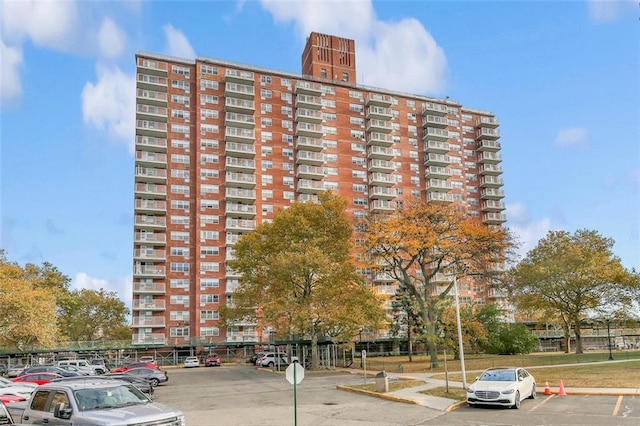 view of building exterior with uncovered parking