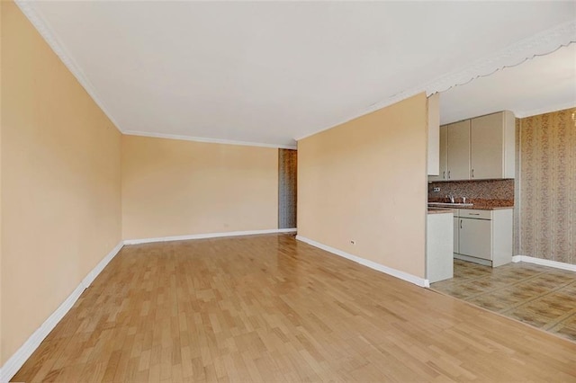 unfurnished living room with ornamental molding and light hardwood / wood-style flooring