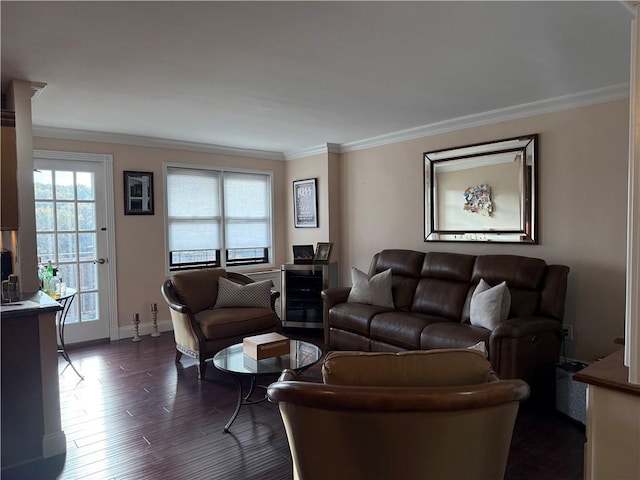 living room featuring ornamental molding, dark wood-type flooring, and baseboards