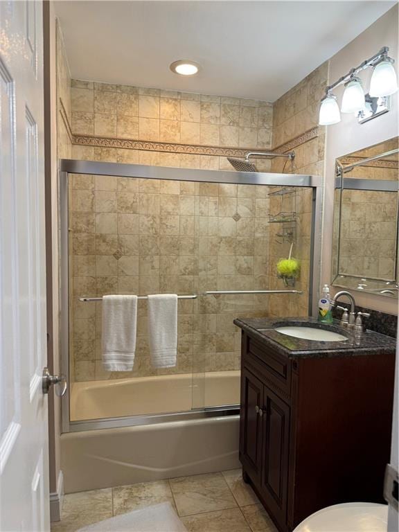 full bathroom with shower / bath combination with glass door, vanity, toilet, and tile patterned floors