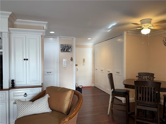 dining room featuring dark wood-type flooring, recessed lighting, crown molding, and a ceiling fan