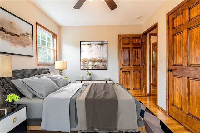 bedroom with light wood-type flooring and ceiling fan