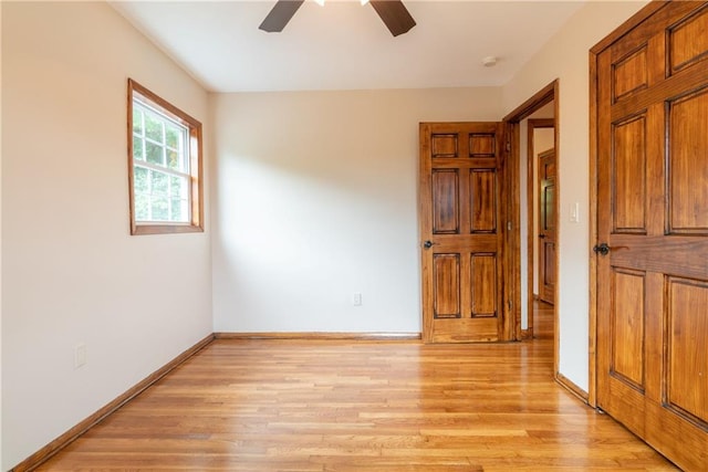 empty room featuring light wood-type flooring and ceiling fan