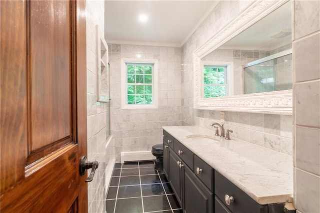 bathroom with toilet, tile walls, an enclosed shower, vanity, and crown molding