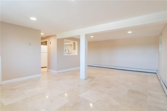 empty room with baseboard heating and sink