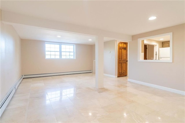 basement featuring white fridge and a baseboard radiator