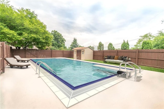 view of pool featuring a patio and a storage unit