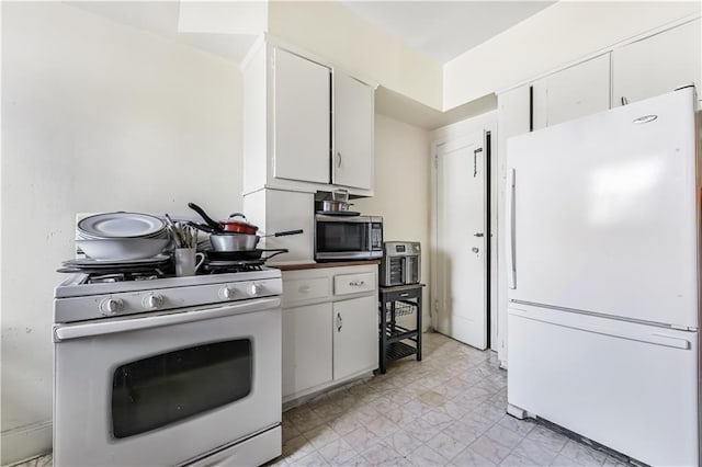 kitchen with white cabinetry and white appliances