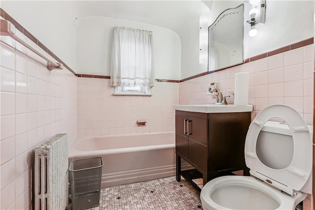 bathroom featuring radiator heating unit, tile walls, a bathtub, tile patterned flooring, and toilet