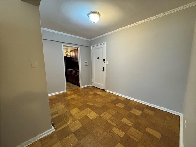 empty room featuring ornamental molding and parquet flooring