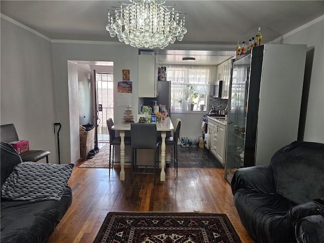 dining room with a chandelier, ornamental molding, plenty of natural light, and dark wood-type flooring