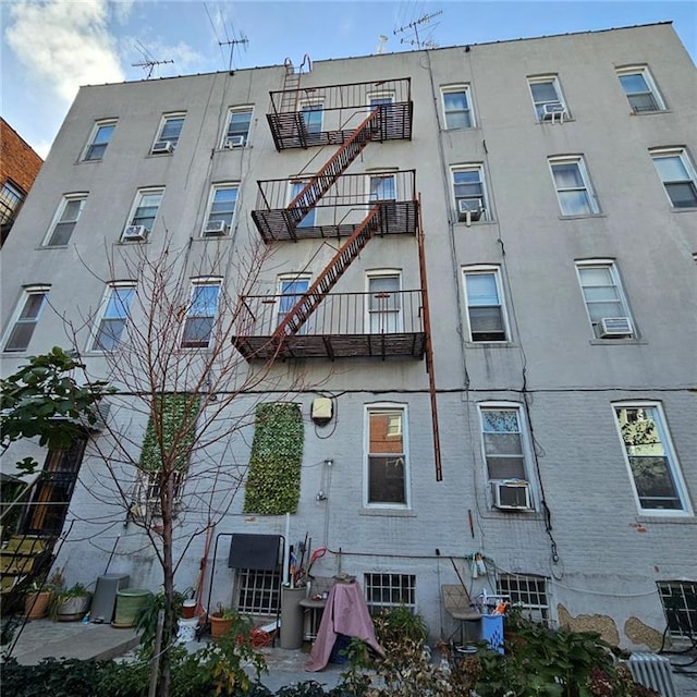 view of building exterior featuring stairway and cooling unit