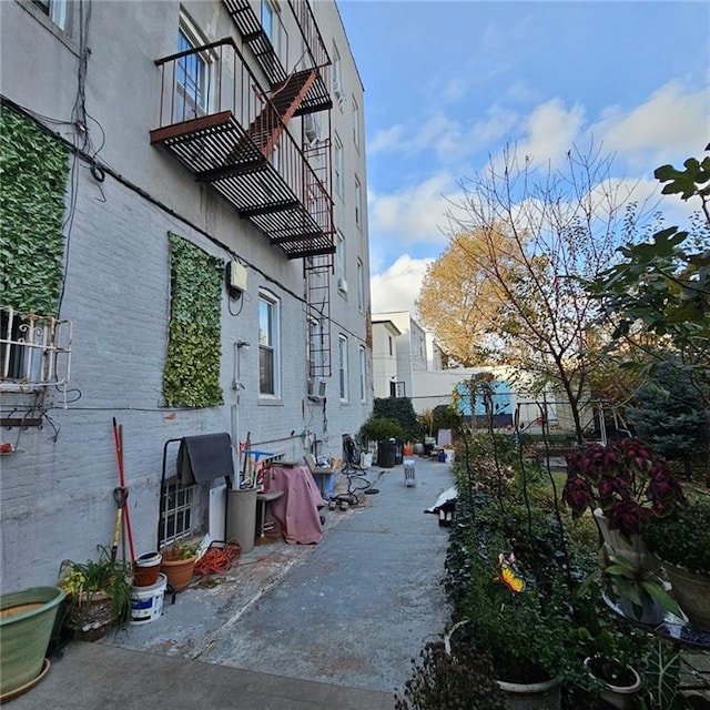 2069 E 12th St, Brooklyn, NY 11229 - view of side of home featuring a balcony, fence, brick siding, and a patio area