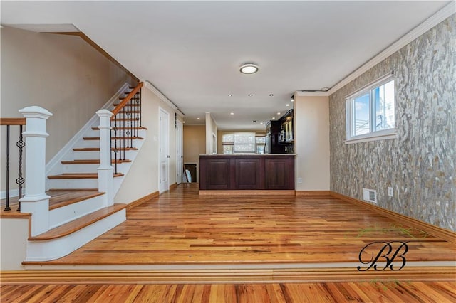 interior space featuring stairs, wood finished floors, visible vents, and baseboards