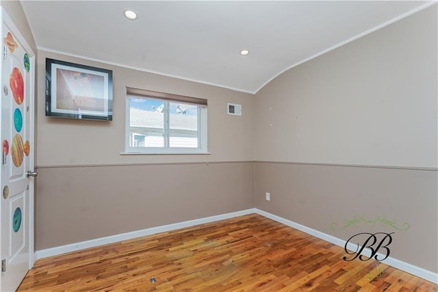 spare room with baseboards, visible vents, wood finished floors, and recessed lighting