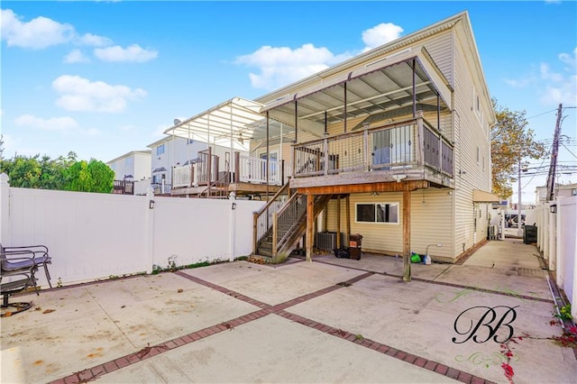 back of house with a fenced backyard, stairs, central AC unit, and a patio