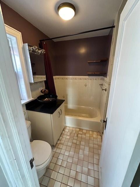 bathroom featuring vanity, shower / bath combination, tile patterned flooring, and toilet