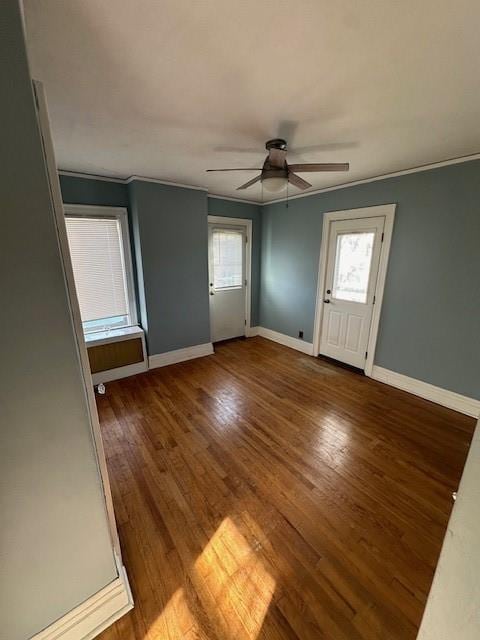 entryway with hardwood / wood-style flooring, ceiling fan, and crown molding