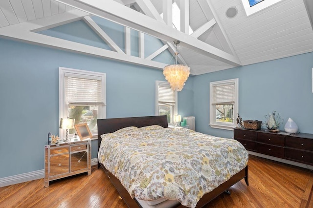 bedroom featuring beamed ceiling, high vaulted ceiling, wood-type flooring, and radiator