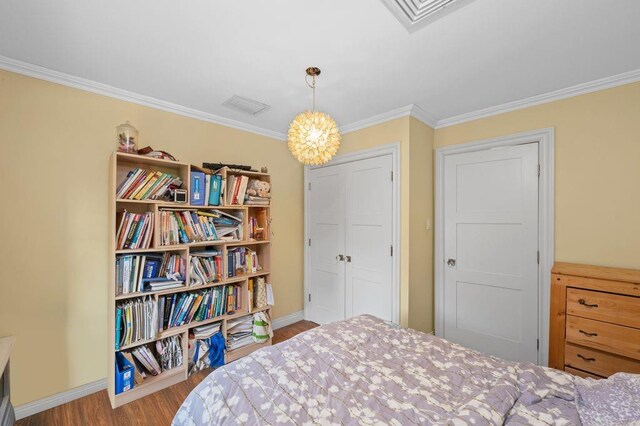 bedroom with a closet, ornamental molding, and light hardwood / wood-style flooring