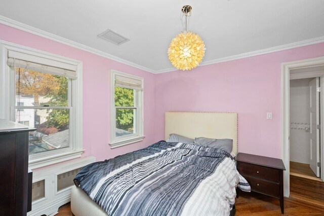 bedroom featuring an inviting chandelier and ornamental molding