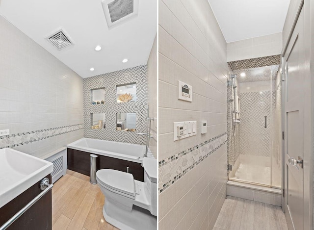 full bathroom featuring vanity, toilet, tile walls, and plus walk in shower