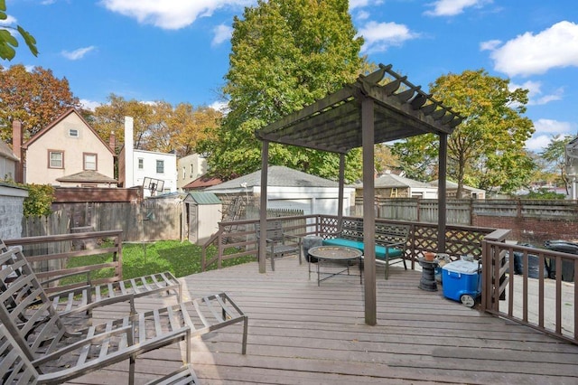 deck with a storage unit and a pergola