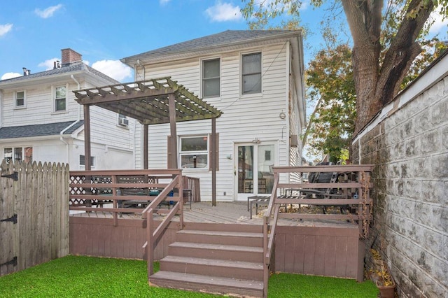 back of house with a pergola and a deck