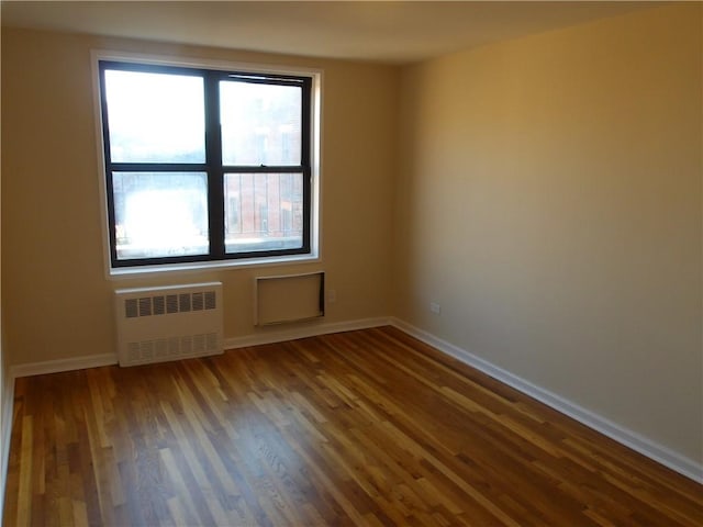 1200 E 53rd St Unit 7B, Brooklyn, NY 11234 - empty room with radiator heating unit, wood finished floors, and baseboards